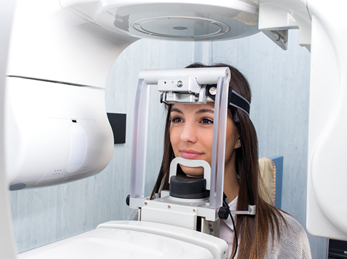 Woman having teeth scanned by cone beam scanner