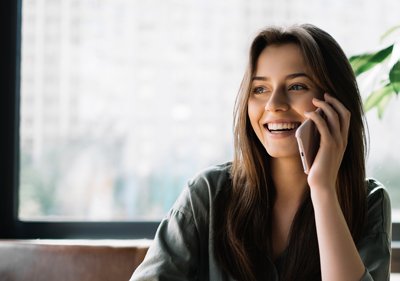 Woman smiling and speaking on phone