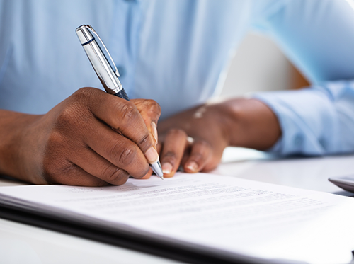 Man filling out form on a clipboard