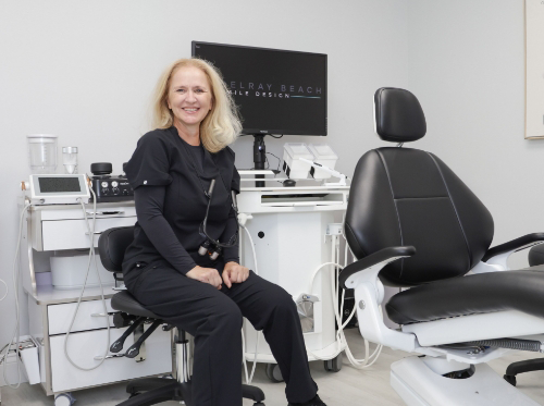 Blonde patient sitting in dental chair and laughing