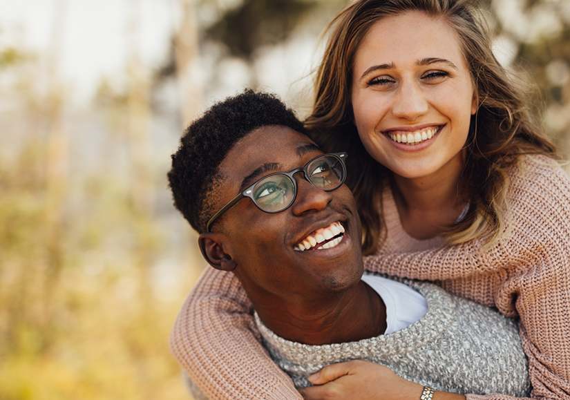 Man giving a woman a piggyback ride