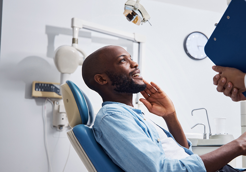 Man sitting in dental chair and smiling